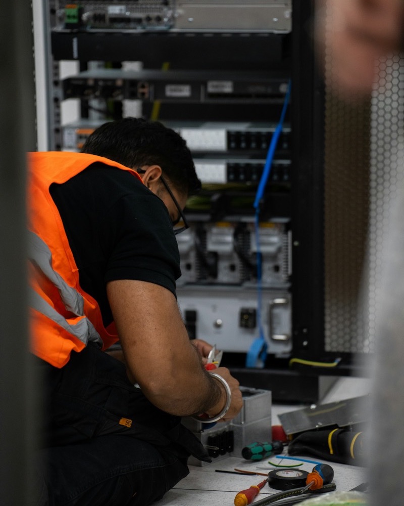 Technician working on server equipment in a rack