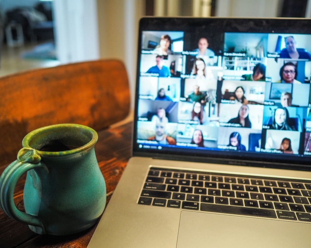 Laptop showing a video meeting with many participants