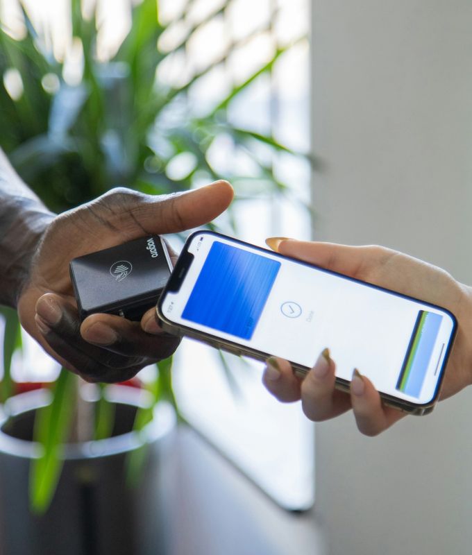 Customer paying with a phone at a card reader