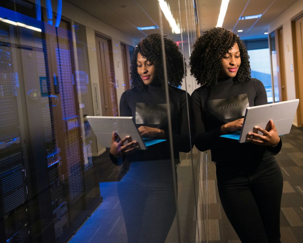 Engineers with tablets in a data centre aisle
