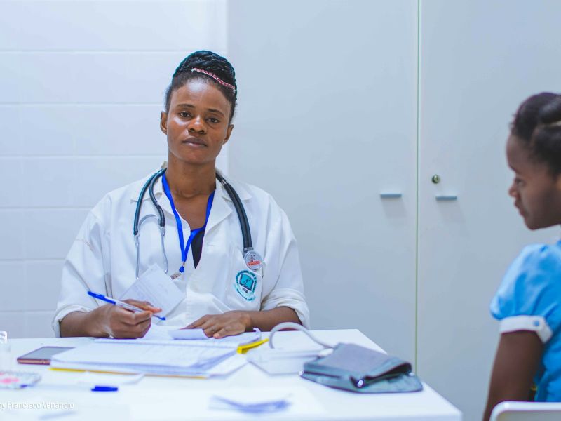 Doctor at her desk with a young patient