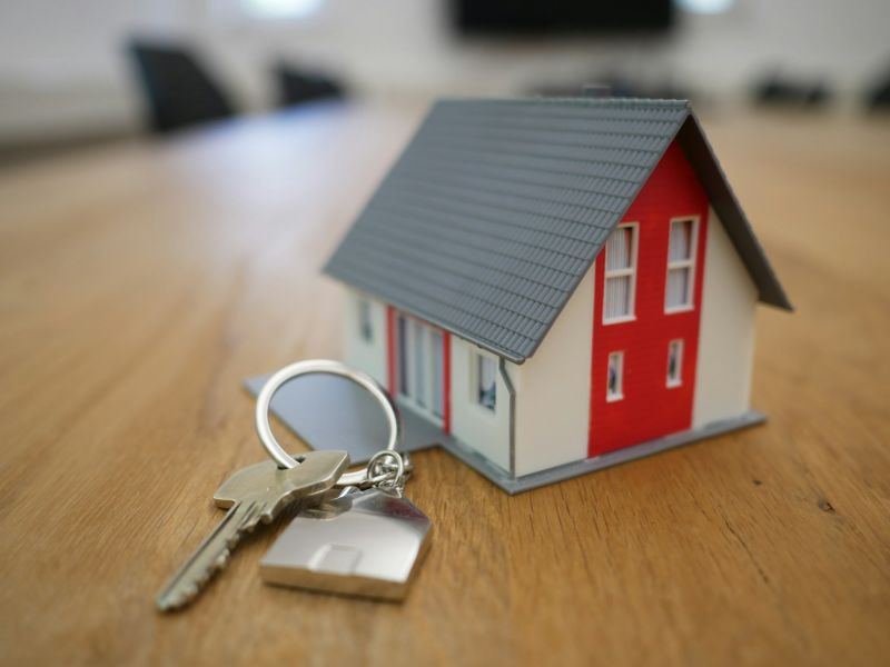House keys next to a small model house