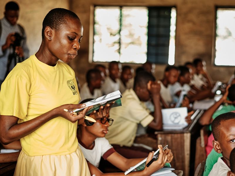 Teacher reading with students in a classroom