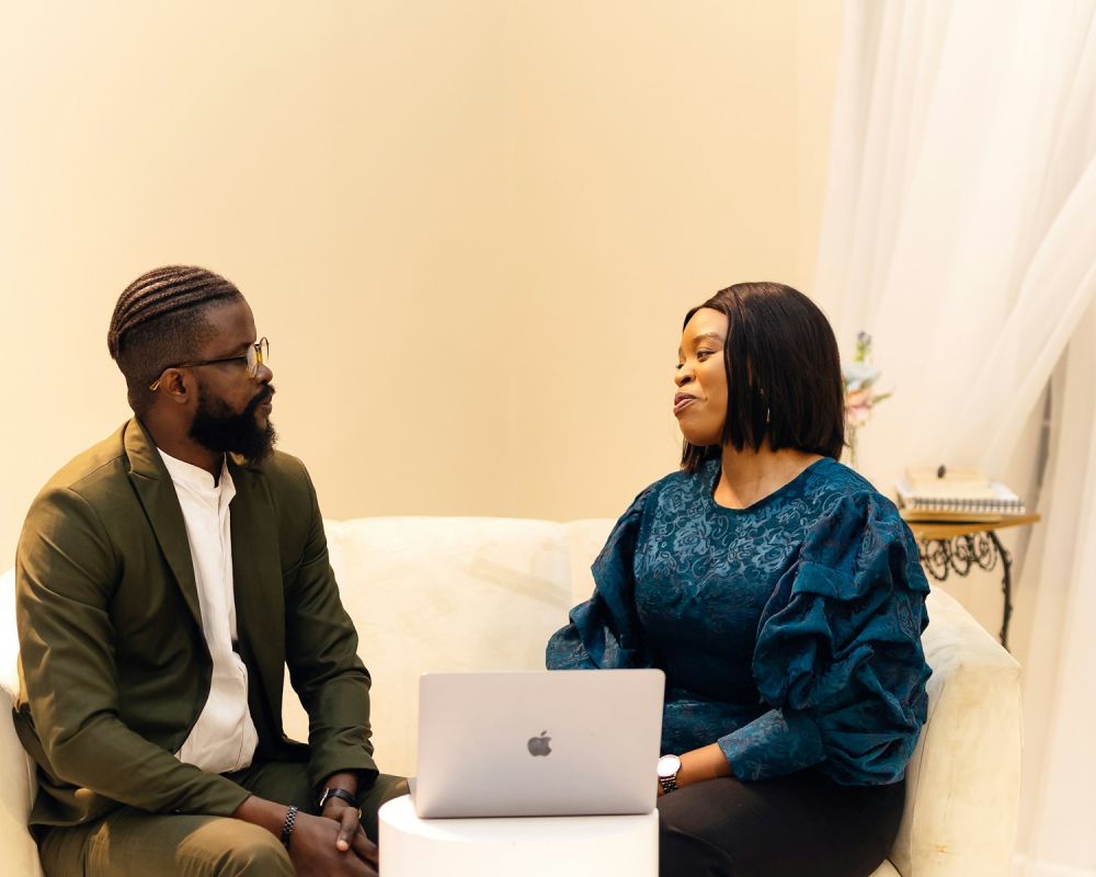 Two people planning a website together at a laptop